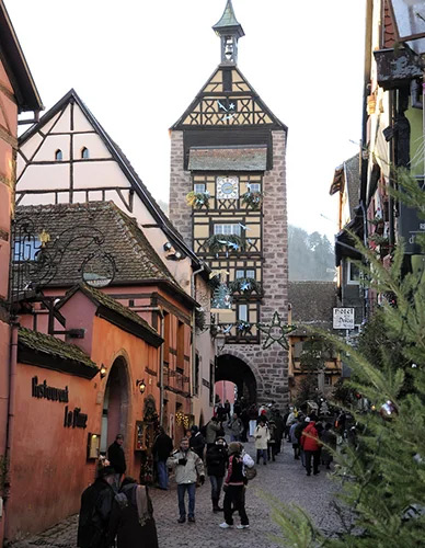 Traditional Alsatian Christmas market with wooden chalets and decorated half-timbered facades